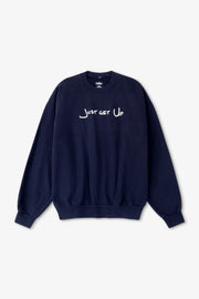 Navy blue sweatshirt with 'Just Get Up' text on a light gray background