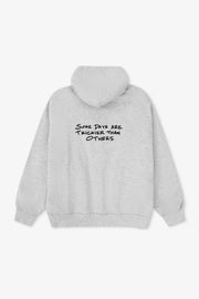 Gray hoodie with text on the back against a white background
