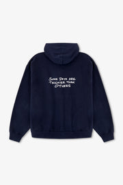 Navy blue hoodie with white text on the back against a light gray background